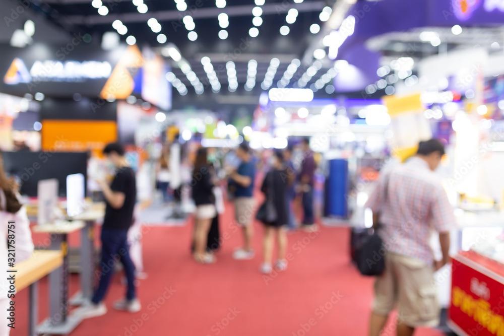 Abstract blur people in exhibition hall event trade show expo background. Business convention show, job fair, or stock market. Organization or company event, commercial trading